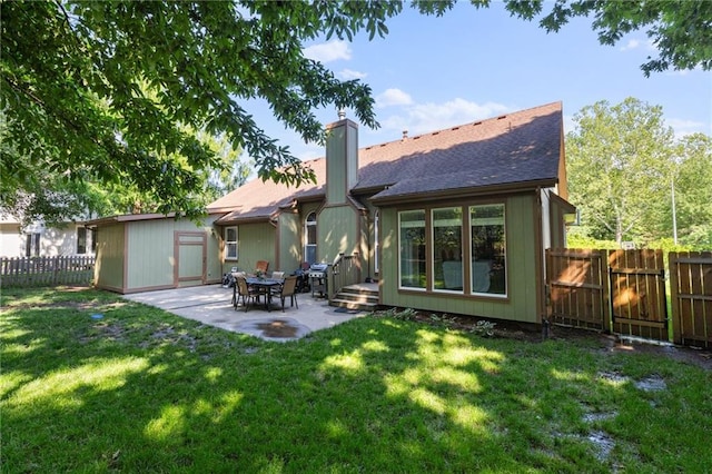 12484 S Hallet St, Olathe, KS 66062 - back of house featuring a patio area, a chimney, and roof with shingles