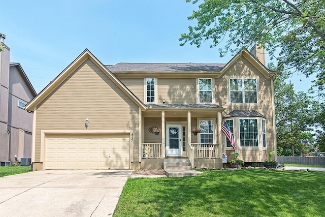 4737 Lone Elm St, Shawnee, KS 66226 - traditional-style house with concrete driveway, covered porch, and a chimney