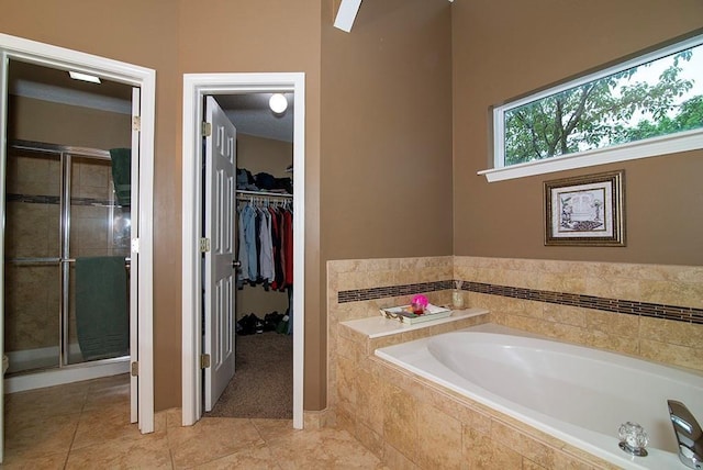 4737 Lone Elm St, Shawnee, KS 66226 - full bath featuring a bath, a shower stall, tile patterned flooring, and a spacious closet