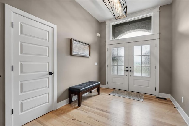 3112 Legacy Wood Dr, Lees Summit, MO 64086 - foyer featuring light wood-type flooring, baseboards, french doors, and a chandelier