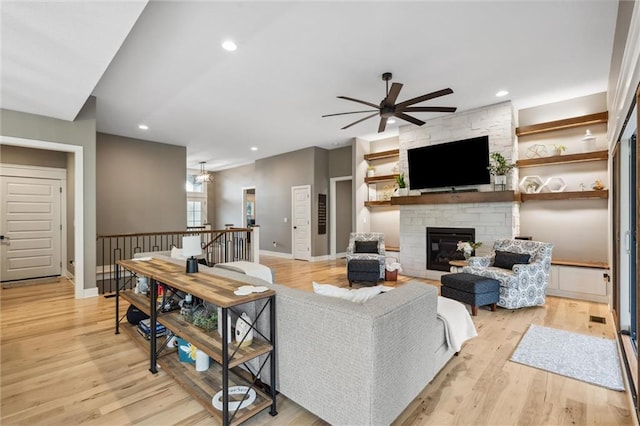 3112 Legacy Wood Dr, Lees Summit, MO 64086 - living area with ceiling fan, a stone fireplace, light wood-type flooring, baseboards, and recessed lighting