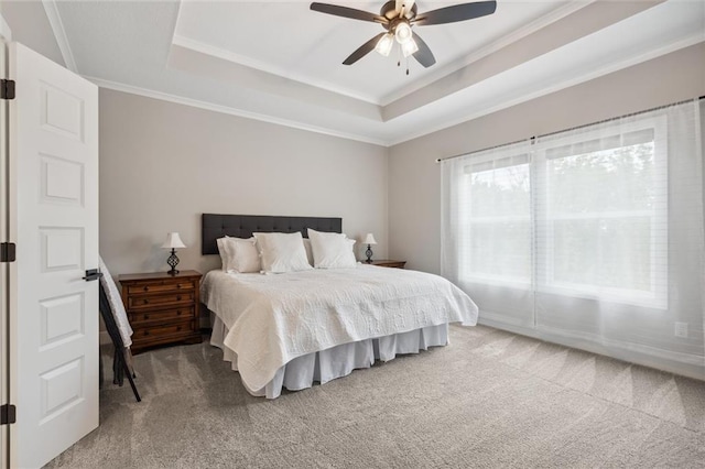 3112 Legacy Wood Dr, Lees Summit, MO 64086 - carpeted bedroom with ornamental molding, a tray ceiling, and a ceiling fan