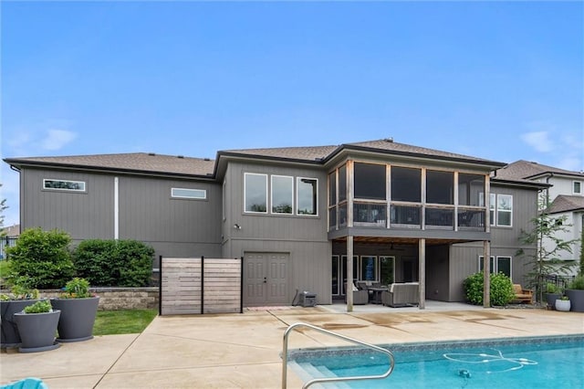 3112 Legacy Wood Dr, Lees Summit, MO 64086 - rear view of house with a patio area, an outdoor pool, and a sunroom