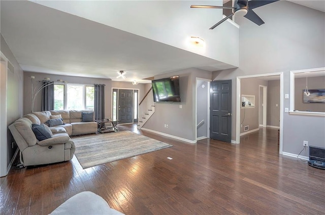 21614 W 72nd St, Shawnee, KS 66218 - living room featuring baseboards, stairs, wood finished floors, a ceiling fan, and a high ceiling