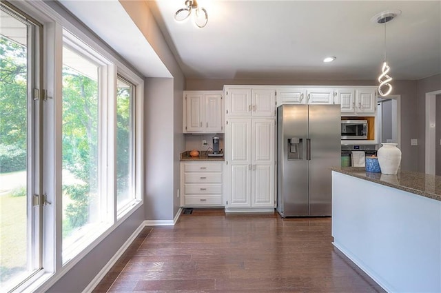 21614 W 72nd St, Shawnee, KS 66218 - kitchen featuring stainless steel appliances, dark stone countertops, white cabinetry, and dark wood-style floors
