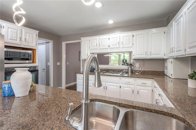 21614 W 72nd St, Shawnee, KS 66218 - kitchen with a sink, stainless steel microwave, white cabinetry, and recessed lighting