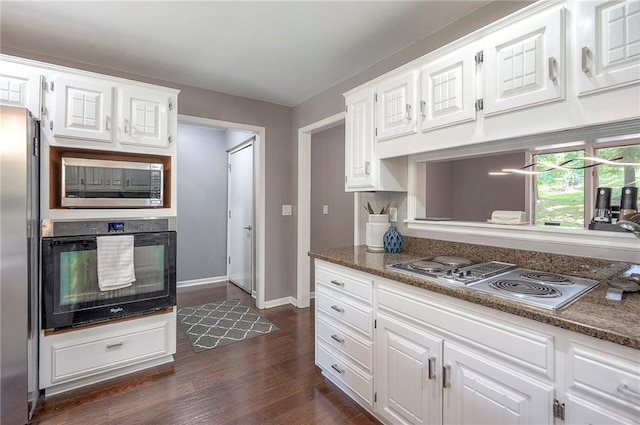 21614 W 72nd St, Shawnee, KS 66218 - kitchen featuring appliances with stainless steel finishes, white cabinets, dark wood-type flooring, and baseboards