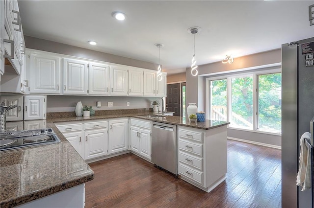 21614 W 72nd St, Shawnee, KS 66218 - kitchen with stainless steel appliances, a peninsula, a sink, white cabinets, and dark stone countertops
