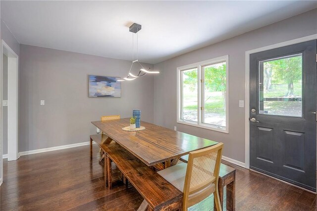 21614 W 72nd St, Shawnee, KS 66218 - dining space with dark wood-style flooring, baseboards, and a chandelier