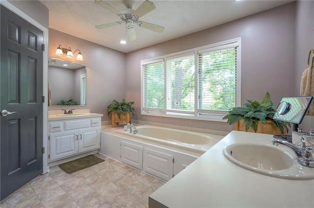 21614 W 72nd St, Shawnee, KS 66218 - full bathroom with vanity, a bath, a ceiling fan, a textured ceiling, and recessed lighting