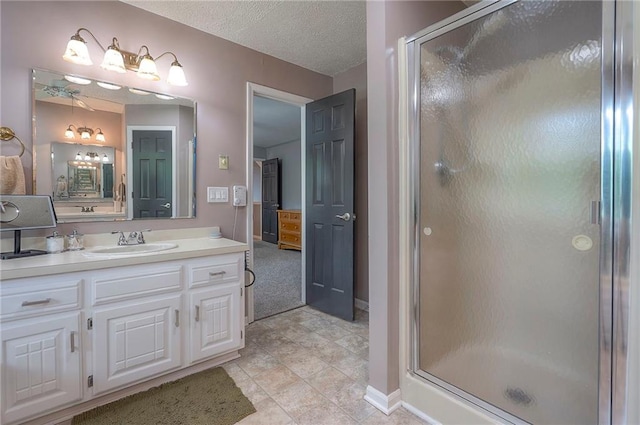 21614 W 72nd St, Shawnee, KS 66218 - bathroom featuring a stall shower, vanity, baseboards, tile patterned floors, and a textured ceiling