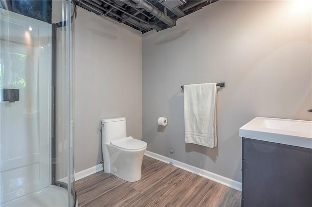 21614 W 72nd St, Shawnee, KS 66218 - full bathroom featuring vanity, a shower stall, wood finished floors, toilet, and baseboards