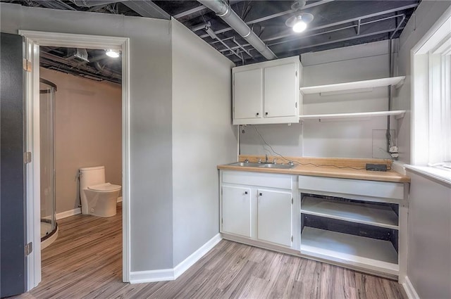 21614 W 72nd St, Shawnee, KS 66218 - bar area with a sink, light wood-style flooring, and baseboards