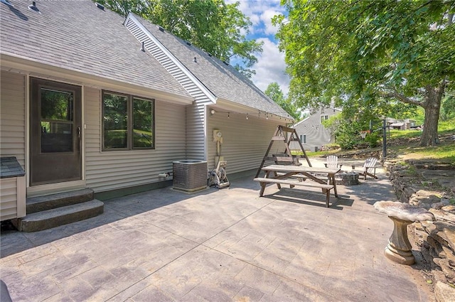 21614 W 72nd St, Shawnee, KS 66218 - view of patio / terrace with an outdoor fire pit, entry steps, and cooling unit