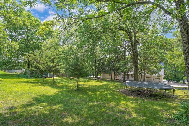 21614 W 72nd St, Shawnee, KS 66218 - view of grassy yard featuring a trampoline