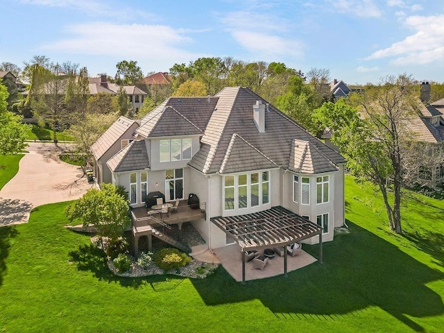 9705 Sunset Cir, Lenexa, KS 66220 - rear view of property with stucco siding, a tiled roof, a lawn, and a deck