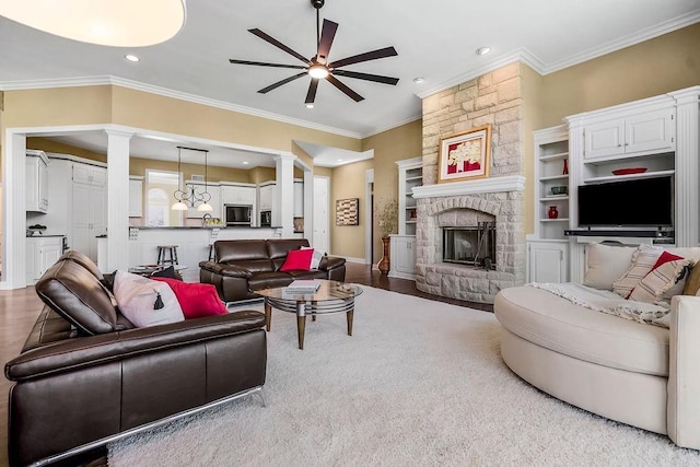 9705 Sunset Cir, Lenexa, KS 66220 - living area with decorative columns, a ceiling fan, ornamental molding, a stone fireplace, and recessed lighting