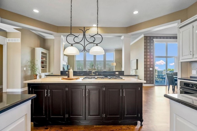 9705 Sunset Cir, Lenexa, KS 66220 - kitchen with white cabinets, a kitchen island with sink, dark wood-type flooring, baseboards, and recessed lighting