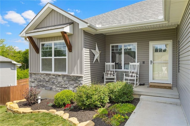 481 Olive Ct, Warrensburg, MO 64093 - entrance to property with a shingled roof, board and batten siding, stone siding, and a porch