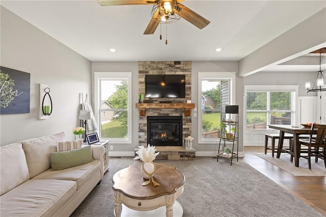 481 Olive Ct, Warrensburg, MO 64093 - living room with a stone fireplace, a ceiling fan, wood finished floors, baseboards, and recessed lighting