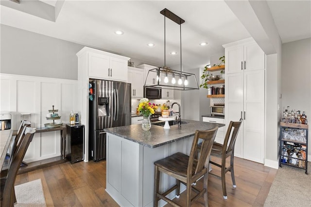 481 Olive Ct, Warrensburg, MO 64093 - kitchen featuring appliances with stainless steel finishes, a sink, open shelves, dark countertops, and recessed lighting