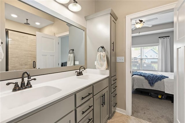 481 Olive Ct, Warrensburg, MO 64093 - full bathroom featuring ensuite bath, double vanity, ceiling fan, a stall shower, and baseboards