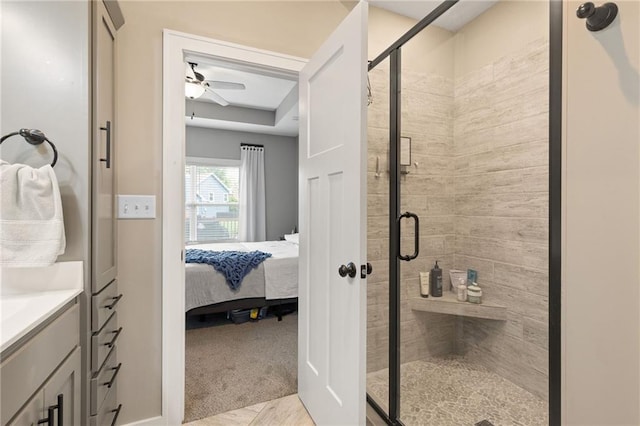 481 Olive Ct, Warrensburg, MO 64093 - ensuite bathroom with a stall shower, a ceiling fan, vanity, and a raised ceiling