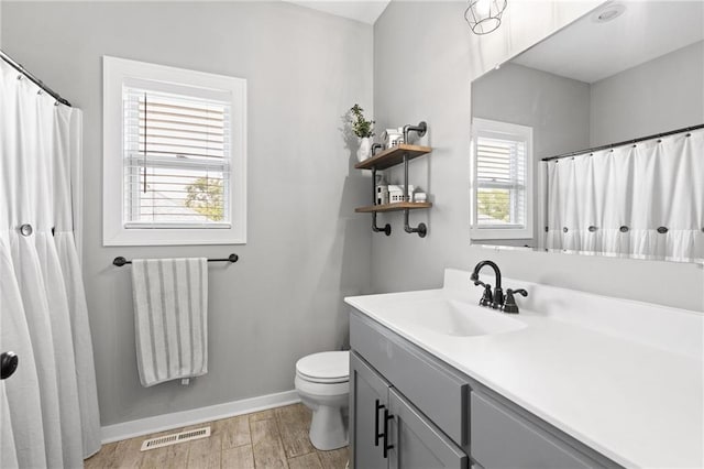 481 Olive Ct, Warrensburg, MO 64093 - bathroom with toilet, wood finished floors, baseboards, vanity, and a shower with shower curtain