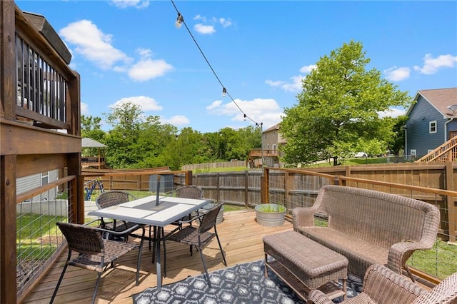 481 Olive Ct, Warrensburg, MO 64093 - wooden terrace featuring outdoor dining space and a fenced backyard