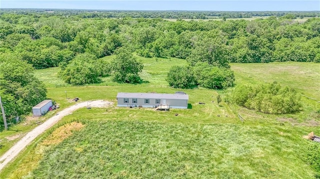 614 SW T Hwy, Holden, MO 64040 - aerial view of property and surrounding area featuring a forest
