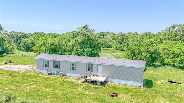 614 SW T Hwy, Holden, MO 64040 - rear view of house featuring a lawn