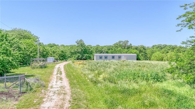 614 SW T Hwy, Holden, MO 64040 - view of yard with a view of trees and dirt driveway