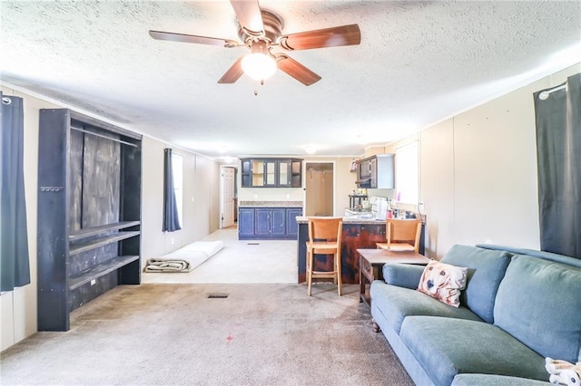 614 SW T Hwy, Holden, MO 64040 - living room with a textured ceiling, light colored carpet, and ceiling fan