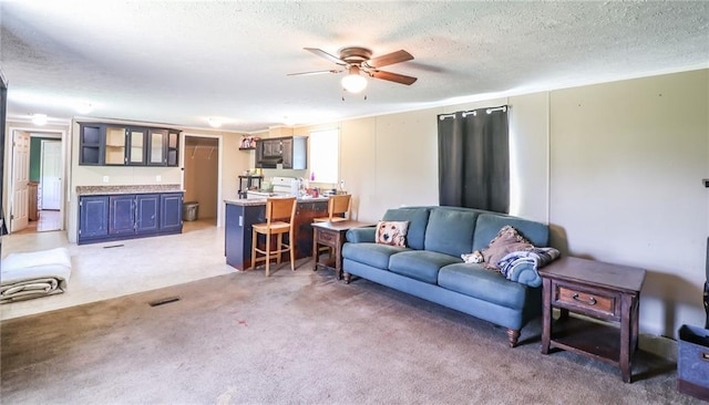 614 SW T Hwy, Holden, MO 64040 - living area featuring light colored carpet, a ceiling fan, and a textured ceiling