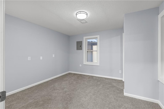 1709 Marty Ave, Kansas City, KS 66103 - unfurnished room with electric panel, a textured ceiling, carpet flooring, and baseboards