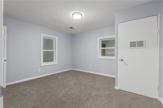 1709 Marty Ave, Kansas City, KS 66103 - carpeted empty room with a textured ceiling and baseboards