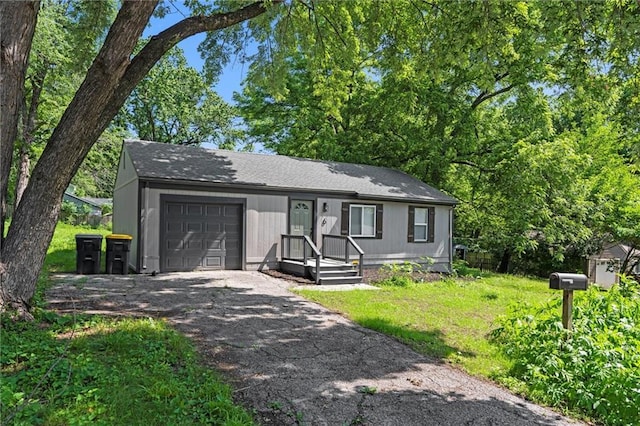 6 W 98th Ter, Kansas City, MO 64114 - view of front facade with an attached garage, asphalt driveway, and a front yard