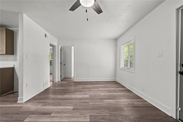 6 W 98th Ter, Kansas City, MO 64114 - unfurnished bedroom with baseboards, wood finished floors, and ceiling fan