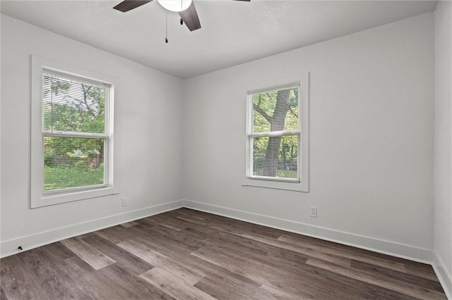 6 W 98th Ter, Kansas City, MO 64114 - spare room featuring a ceiling fan, dark wood-style floors, and baseboards