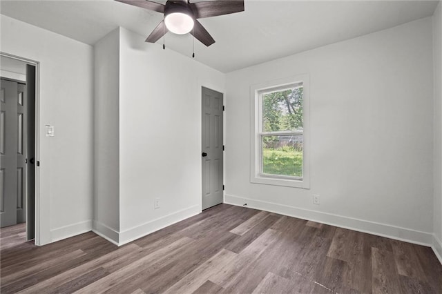 6 W 98th Ter, Kansas City, MO 64114 - unfurnished bedroom featuring wood finished floors, baseboards, and ceiling fan