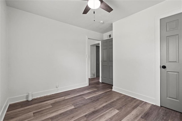 6 W 98th Ter, Kansas City, MO 64114 - unfurnished bedroom featuring wood finished floors, baseboards, and ceiling fan