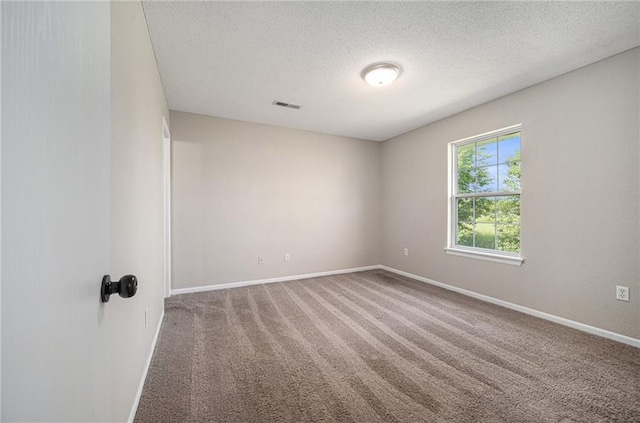 214 NW Parker Dr, Grain Valley, MO 64029 - unfurnished room with baseboards, carpet, and a textured ceiling