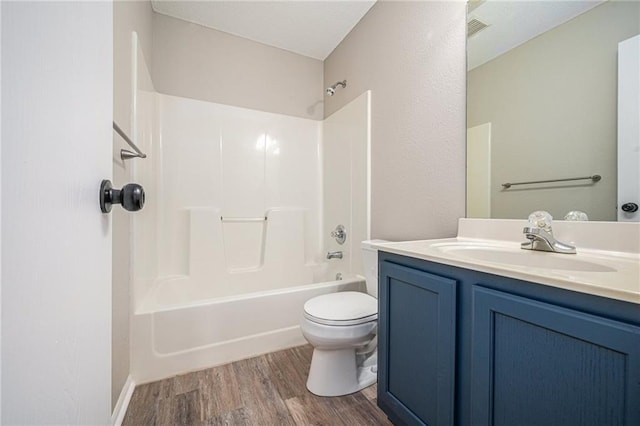 214 NW Parker Dr, Grain Valley, MO 64029 - full bathroom featuring wood finished floors, toilet, vanity, and shower / bath combination