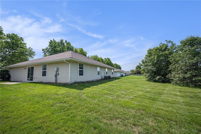 214 NW Parker Dr, Grain Valley, MO 64029 - back of property featuring a yard and central AC unit
