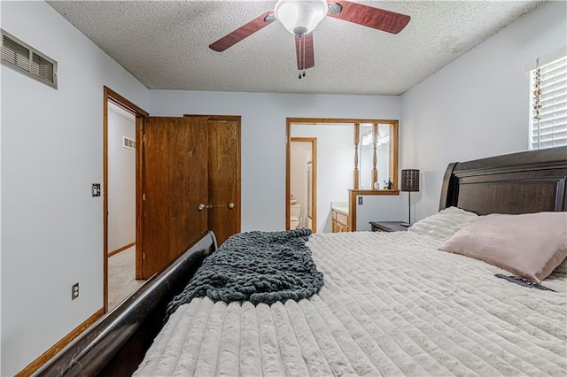 516 S St, Grain Valley, MO 64029 - bedroom with a textured ceiling, a ceiling fan, and ensuite bath