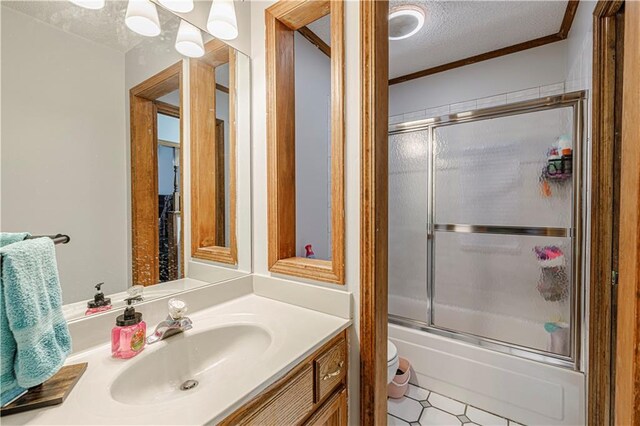 516 S St, Grain Valley, MO 64029 - bathroom with a textured ceiling, vanity, bath / shower combo with glass door, and crown molding