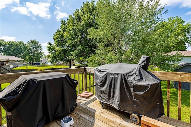 516 S St, Grain Valley, MO 64029 - wooden terrace featuring area for grilling and a lawn