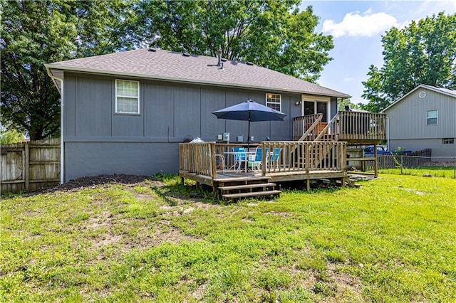 516 S St, Grain Valley, MO 64029 - rear view of house with a wooden deck, a fenced backyard, and roof with shingles