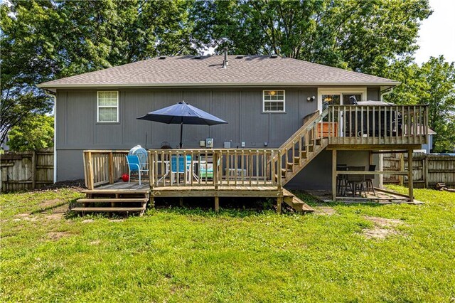 516 S St, Grain Valley, MO 64029 - back of house featuring a wooden deck, a fenced backyard, stairs, and a shingled roof