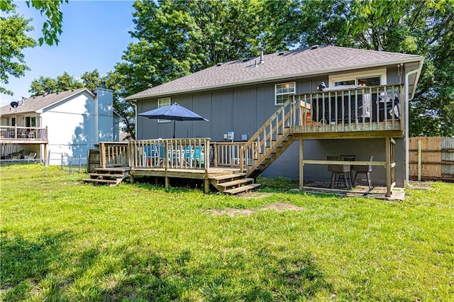 516 S St, Grain Valley, MO 64029 - back of property featuring a deck, a fenced backyard, board and batten siding, roof with shingles, and stairway
